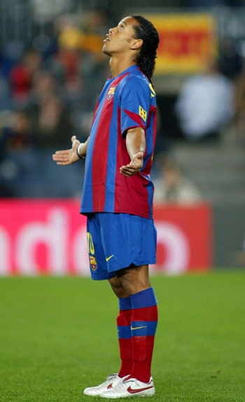 FC Barcelona's Brazilian soccer star Ronaldinho stands on the field, the day after winning 2004 FIFA World Footballer of the Year in Zurich, before the Spanish first division soccer match against Levante at Nou Camp stadium, Spain, December 21, 2004. Ronaldinho, 24, totalled 620 points followed by Thierry Henry of Arsenal and France on 552. REUTERS/Gustau Nacarino